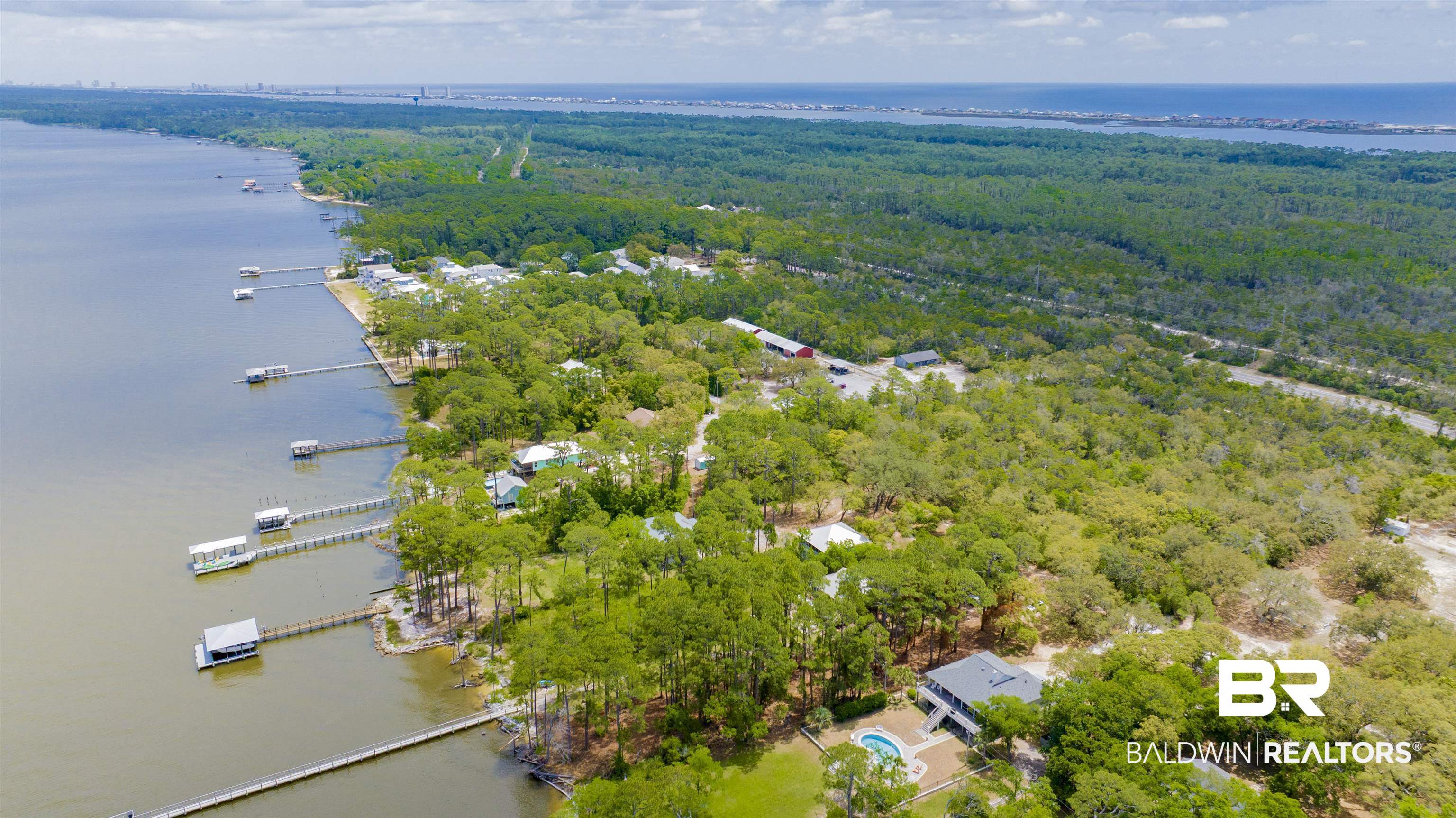 12171 Strong Road Gulf Shores, AL 36542 - Photo 12 of 27 Birds eye view of property featuring a water view and a forest view