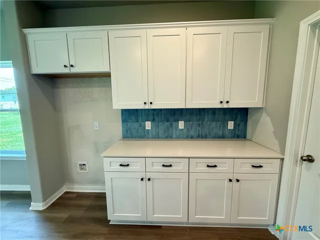 a view of cabinets with wooden floor