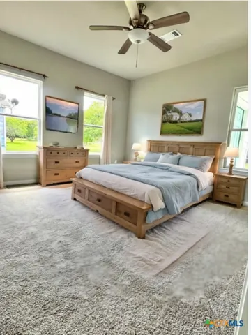 a spacious bedroom with a bed and window