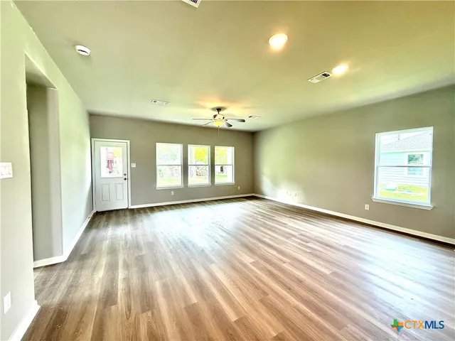a view of an empty room and glass door