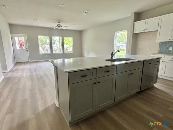 a spacious bathroom with a granite countertop sink window and a mirror