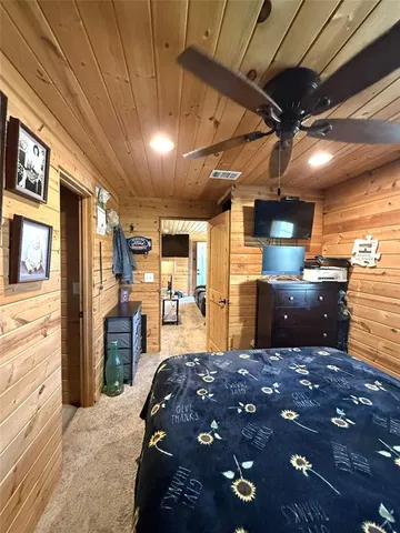 a large bedroom with a bed and a chandelier