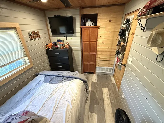 a bedroom with a bed and flat screen tv