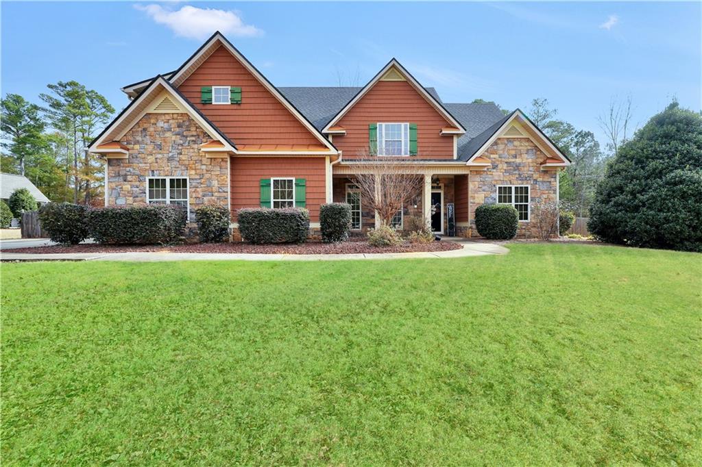 108 Caraway Road Locust Grove, GA 30248 - Photo 1 of 50 a front view of a house with a yard and green space