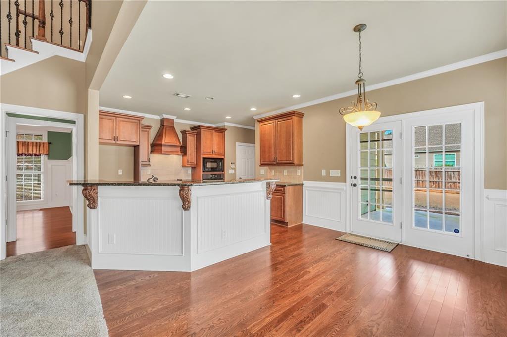 108 Caraway Road Locust Grove, GA 30248 - Photo 12 of 50 a view of kitchen with stainless steel appliances granite countertop a stove top oven a refrigerator a sink and a dining table with wooden floor
