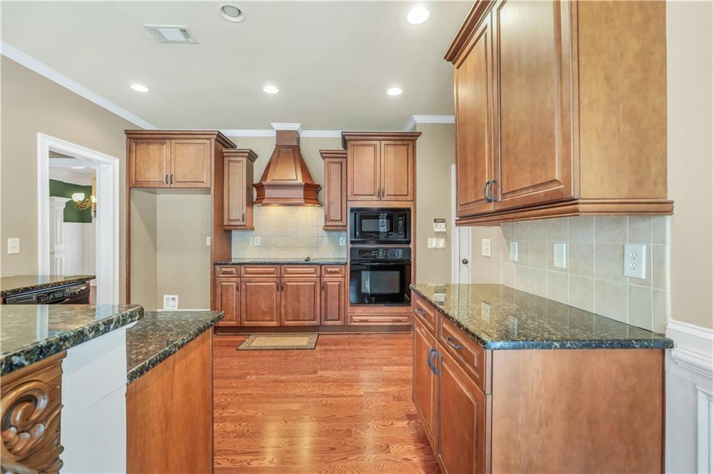 108 Caraway Road Locust Grove, GA 30248 - Photo 14 of 50 a kitchen with stainless steel appliances granite countertop a sink refrigerator and cabinets
