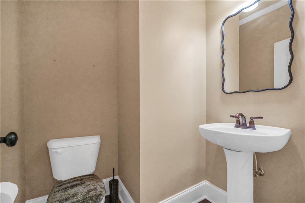 108 Caraway Road Locust Grove, GA 30248 - Photo 19 of 50 a bathroom with a sink toilet and a mirror