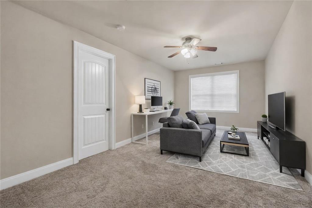108 Caraway Road Locust Grove, GA 30248 - Photo 23 of 50 a living room with furniture and a flat screen tv