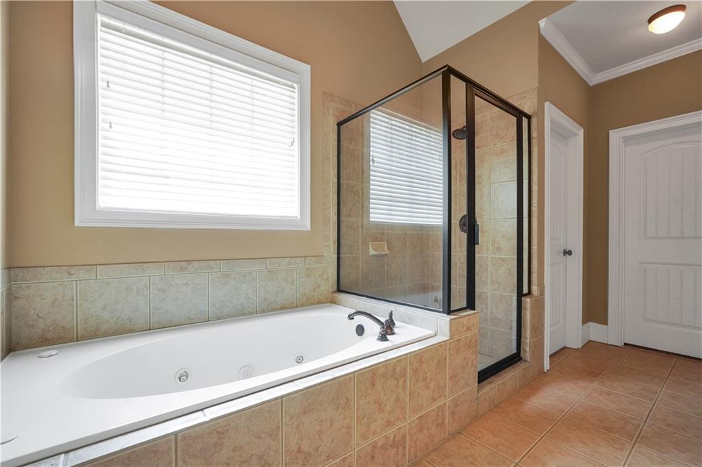 108 Caraway Road Locust Grove, GA 30248 - Photo 30 of 50 a bathroom with a bathtub and a shower