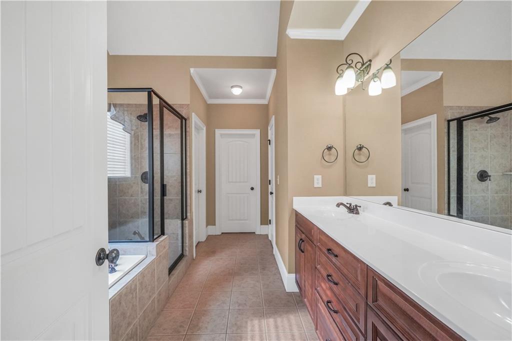 108 Caraway Road Locust Grove, GA 30248 - Photo 31 of 50 a spacious bathroom with a double vanity sink a mirror and shower