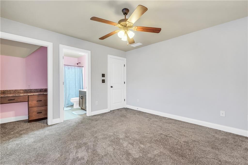 108 Caraway Road Locust Grove, GA 30248 - Photo 33 of 50 an empty room with a ceiling fan and a window