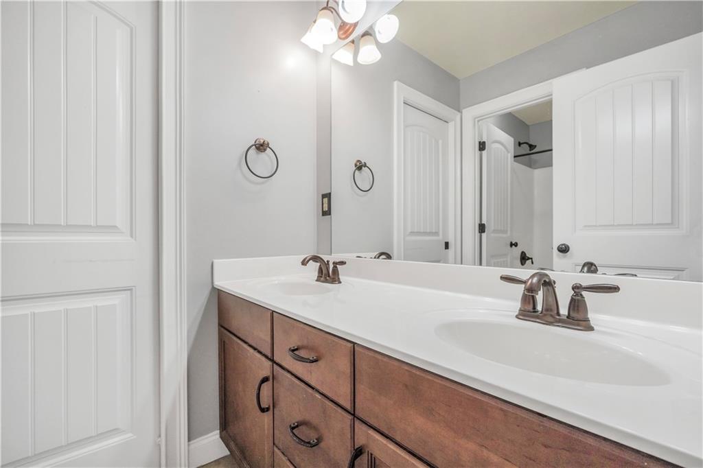 108 Caraway Road Locust Grove, GA 30248 - Photo 36 of 50 a bathroom with a sink and a mirror