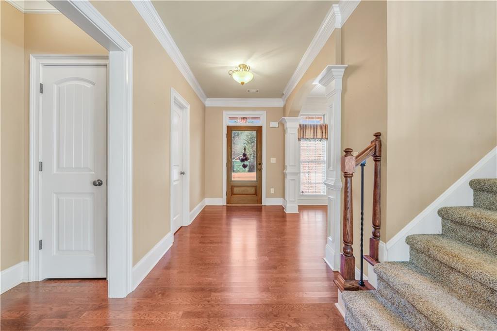 108 Caraway Road Locust Grove, GA 30248 - Photo 6 of 50 a view of a hallway with wooden floor and staircase