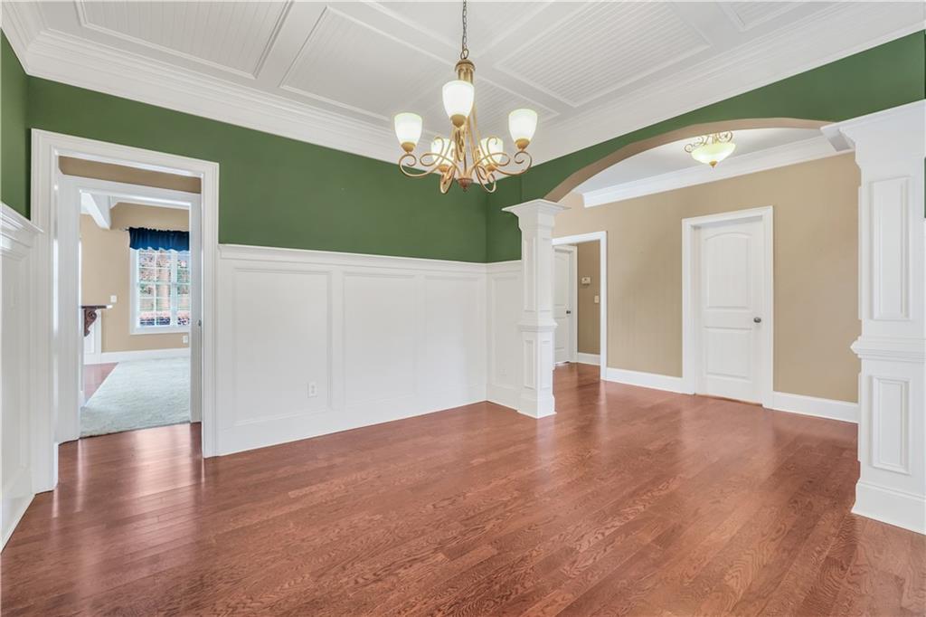108 Caraway Road Locust Grove, GA 30248 - Photo 8 of 50 a view of an empty room with wooden floor and a chandelier