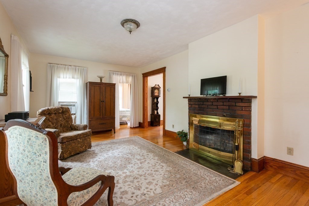 25 Porter Street Danvers, MA 01923 - Photo 11 of 42 a living room with furniture and a fireplace