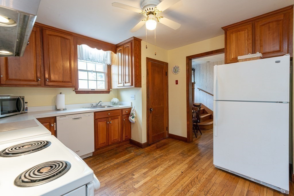 25 Porter Street Danvers, MA 01923 - Photo 18 of 42 a kitchen with a refrigerator and a stove top oven
