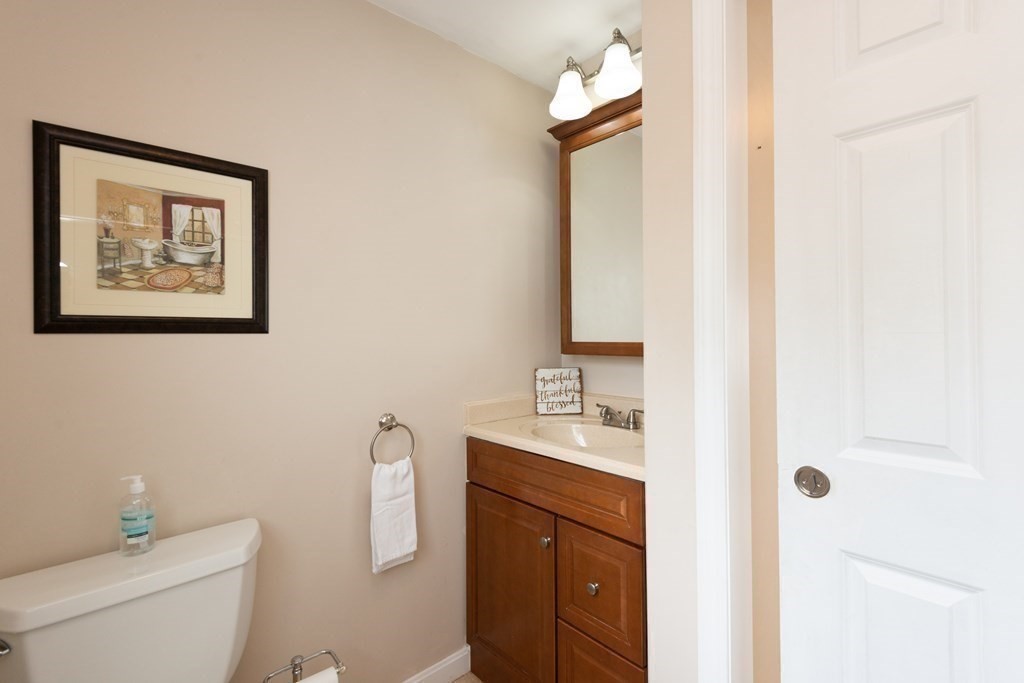 25 Porter Street Danvers, MA 01923 - Photo 29 of 42 a bathroom with a toilet sink vanity and mirror
