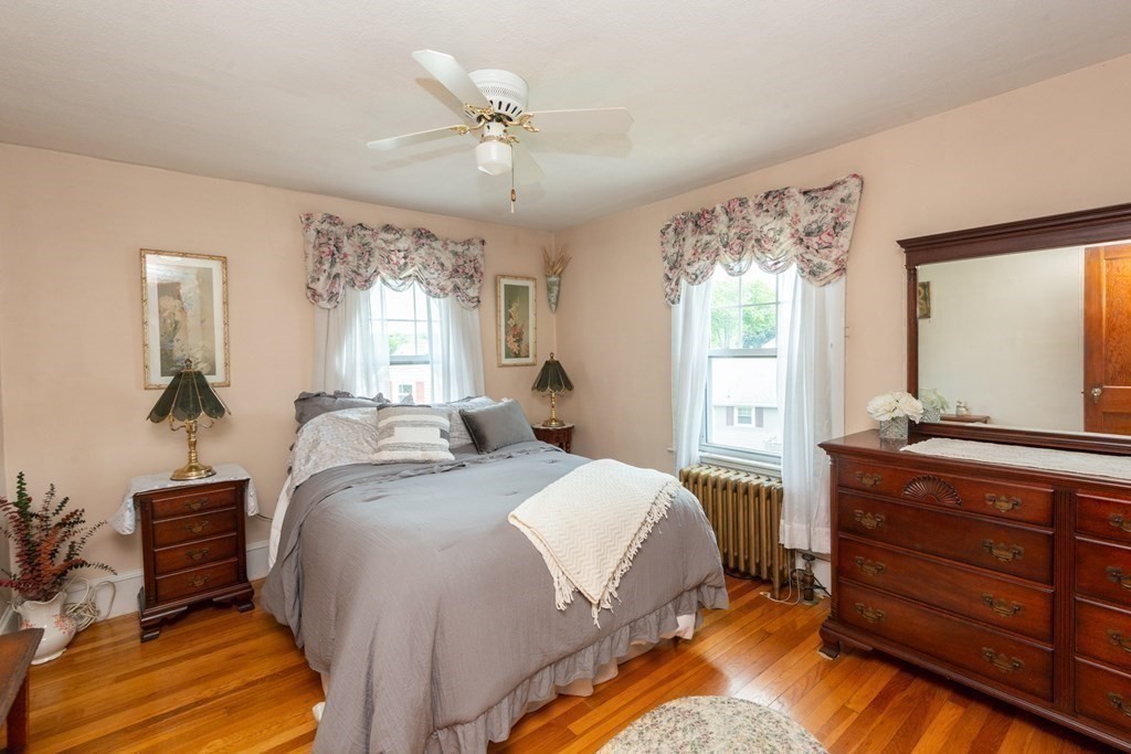 25 Porter Street Danvers, MA 01923 - Photo 30 of 42 a bedroom with a bed a chandelier and a dresser