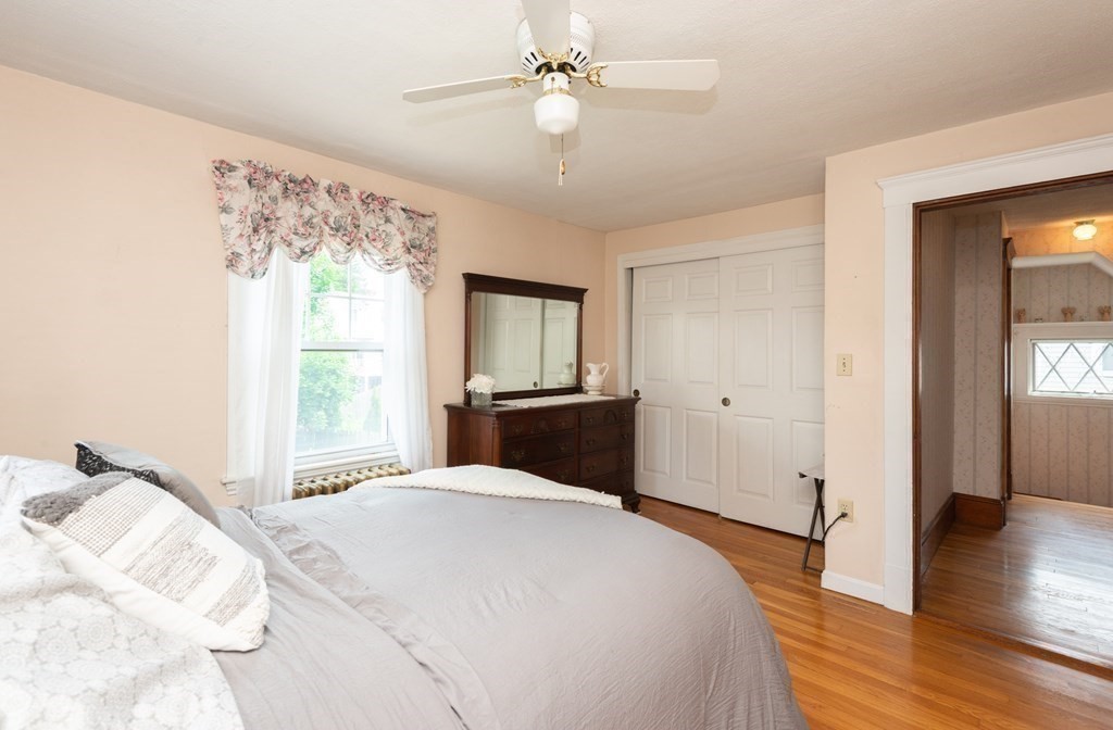 25 Porter Street Danvers, MA 01923 - Photo 31 of 42 a bedroom with a large bed and a chandelier