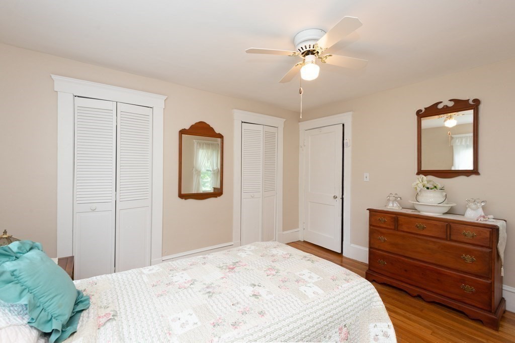 25 Porter Street Danvers, MA 01923 - Photo 34 of 42 a bedroom with a bed and a chandelier