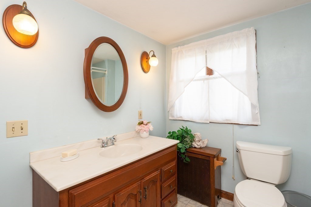25 Porter Street Danvers, MA 01923 - Photo 37 of 42 a bathroom with a toilet a sink and a mirror