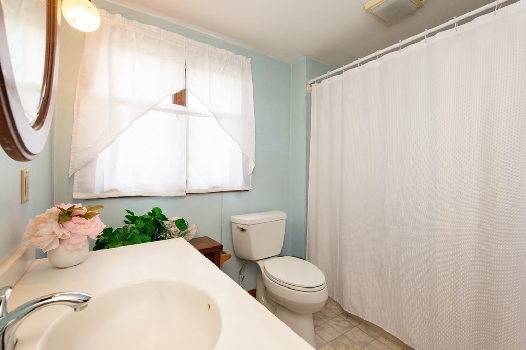 25 Porter Street Danvers, MA 01923 - Photo 38 of 42 a bathroom with a sink toilet and shower