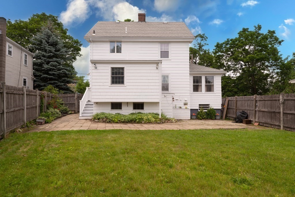 25 Porter Street Danvers, MA 01923 - Photo 6 of 42 a front view of house with yard and trees in the background