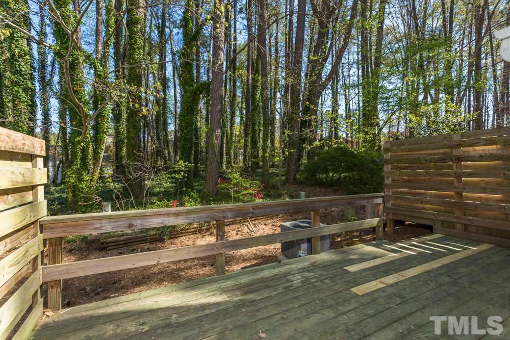 1306 Springlawn Court Raleigh, NC 27609 - Photo 14 of 19 a view of a yard with wooden fence