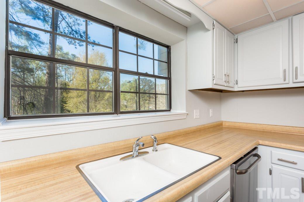 1306 Springlawn Court Raleigh, NC 27609 - Photo 4 of 19 a bathroom with a sink and a window