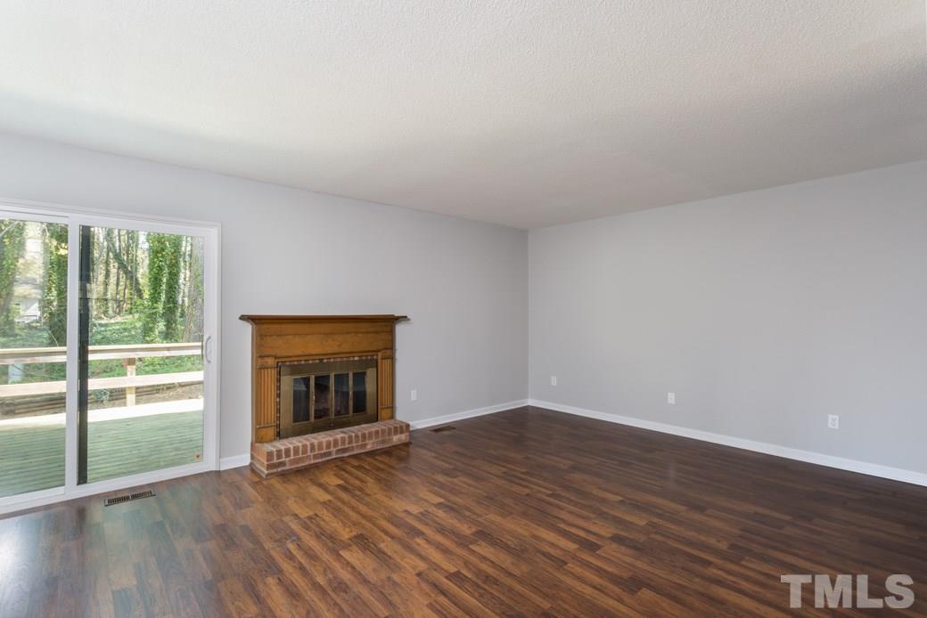 1306 Springlawn Court Raleigh, NC 27609 - Photo 5 of 19 wooden floor in an empty room with a window
