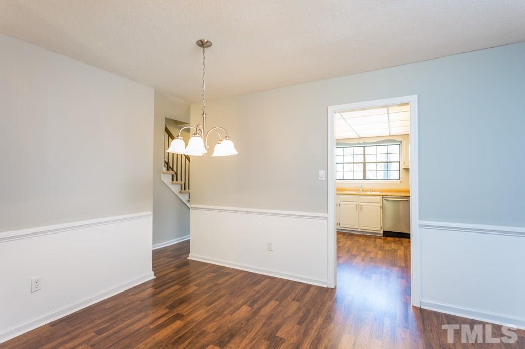 1306 Springlawn Court Raleigh, NC 27609 - Photo 7 of 19 a view of a room with wooden floor and a window
