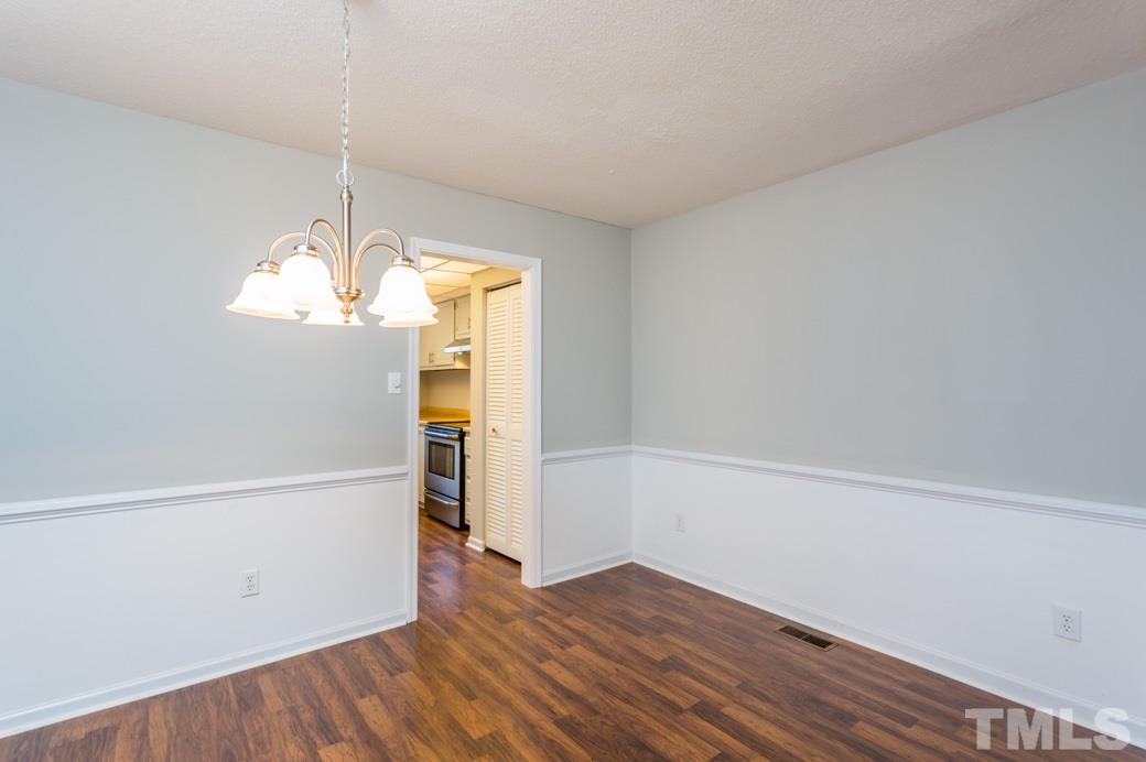 1306 Springlawn Court Raleigh, NC 27609 - Photo 8 of 19 a view of empty room with wooden floor