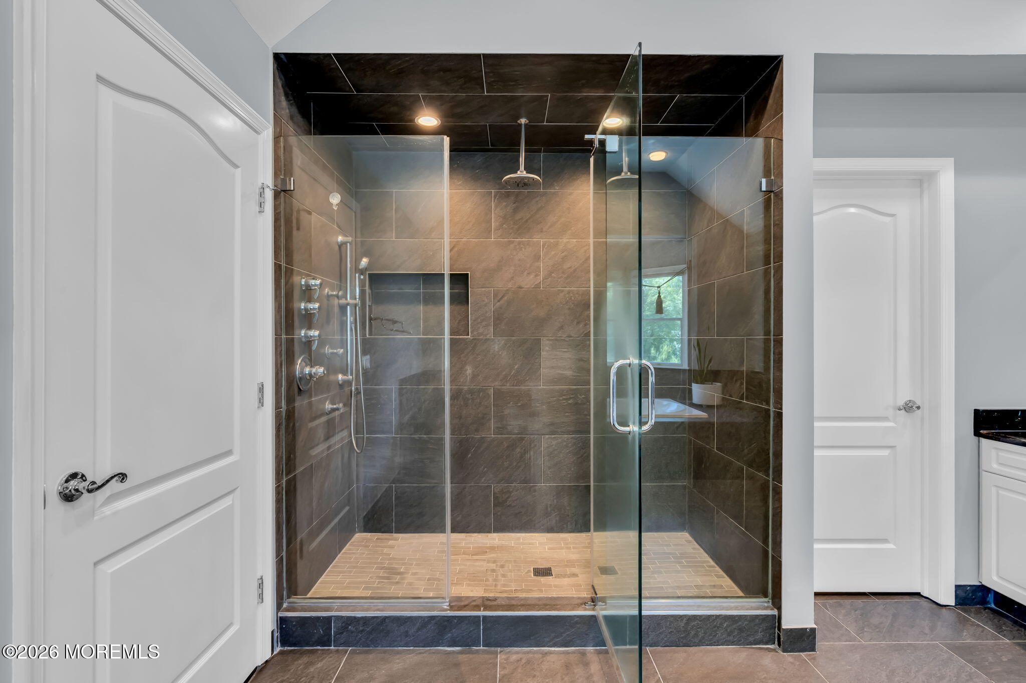 14 Diamond Hill Road Marlboro, NJ 07746 - Photo 42 of 79 a bathroom with a glass shower door