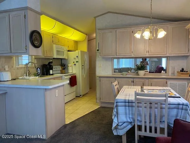 a kitchen with a sink a stove and cabinets