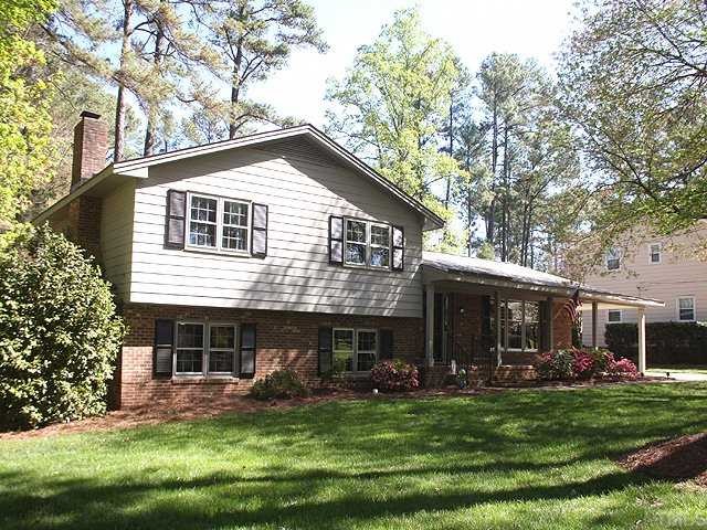 1007 Country Ridge Drive Raleigh, NC 27609 - Photo 1 of 14 a front view of a house with a garden and trees