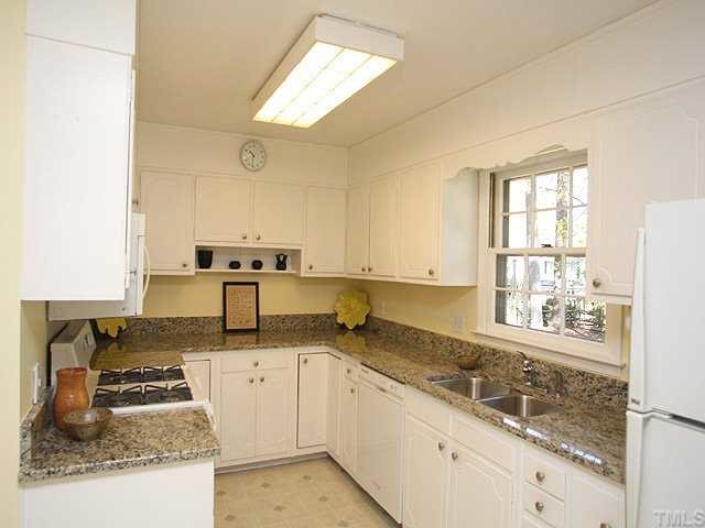 1007 Country Ridge Drive Raleigh, NC 27609 - Photo 4 of 14 a kitchen with a sink stove and cabinets