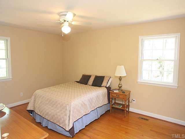 1007 Country Ridge Drive Raleigh, NC 27609 - Photo 6 of 14 a bedroom with a bed and a chandelier