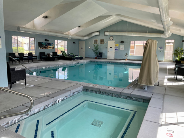 1204 South 1150th Street West Payson, UT 84651 - Photo 24 of 26 Clubhouse Indoor year round heated swimming pool featuring a vaulted ceiling with exposed ductwork, a separate integrated hot tub, and surrounding windows