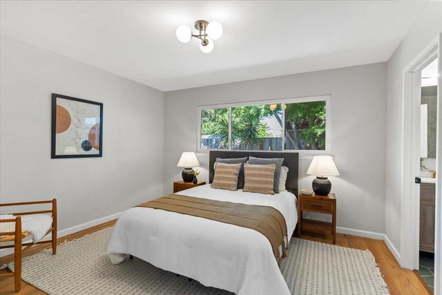 a bedroom with a large bed and a window