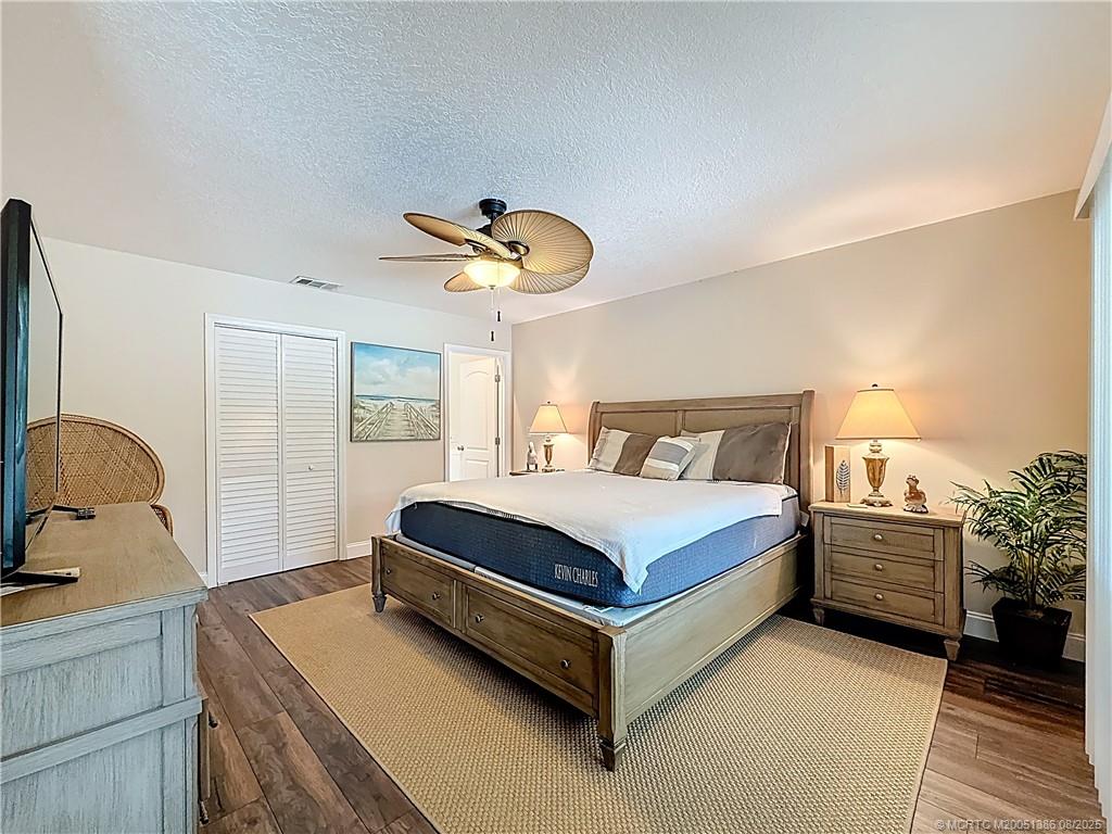 2082 Southeast Pyramid Road Port St. Lucie, FL 34952 - Photo 42 of 87 WITH BATHROOM AND LG SHOWER AND DOUBLE SINKS. WALK IN CLOSET. SLIDER OUT TO POOL AND PATIO AREA. FAN. UPDATED VINYL PLANKS FOR THE FLOORING.