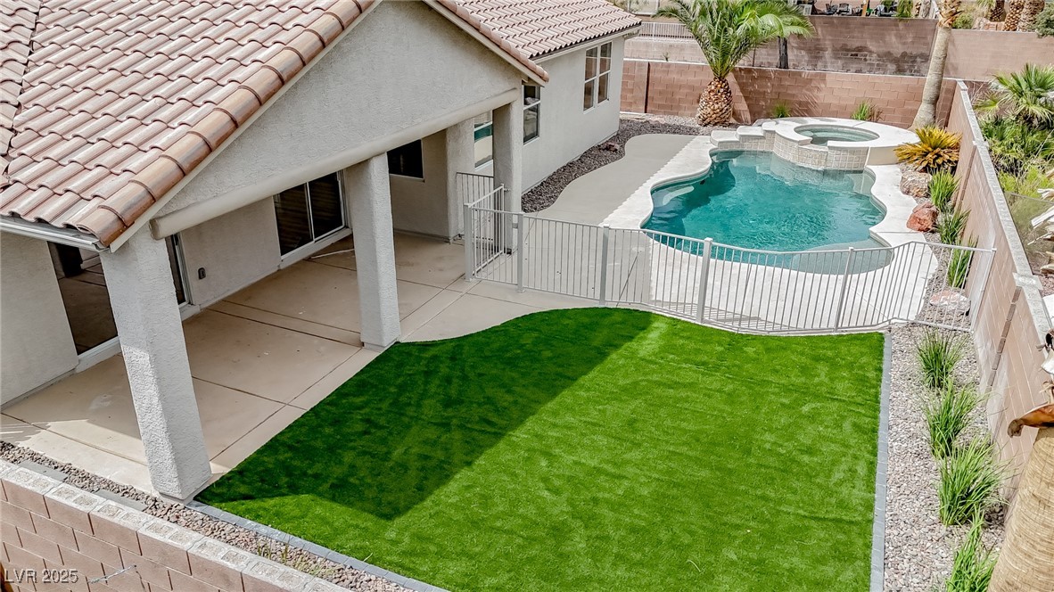 7870 Midnight Ride Street Las Vegas, NV 89131 - Photo 2 of 69 View of pool with a fenced backyard, a patio, and a pool with connected hot tub