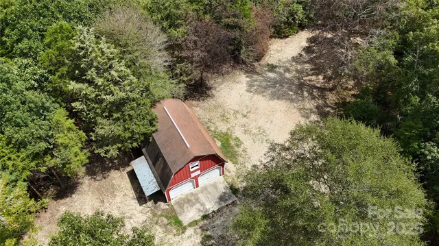 a view of a yard with wooden fence and plants