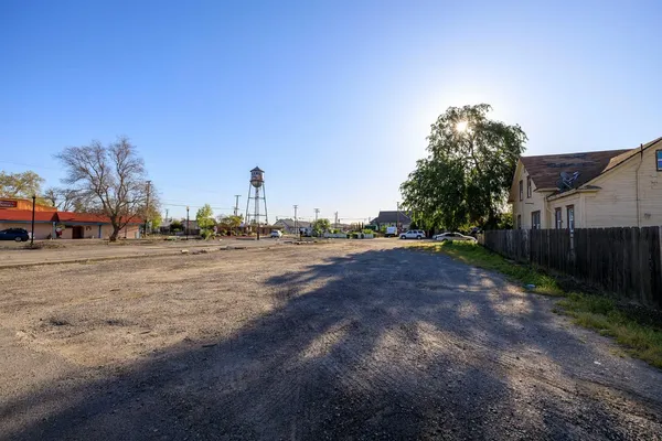 a view of road with large trees