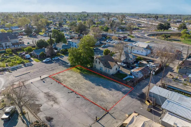 an aerial view of a residential houses with outdoor space