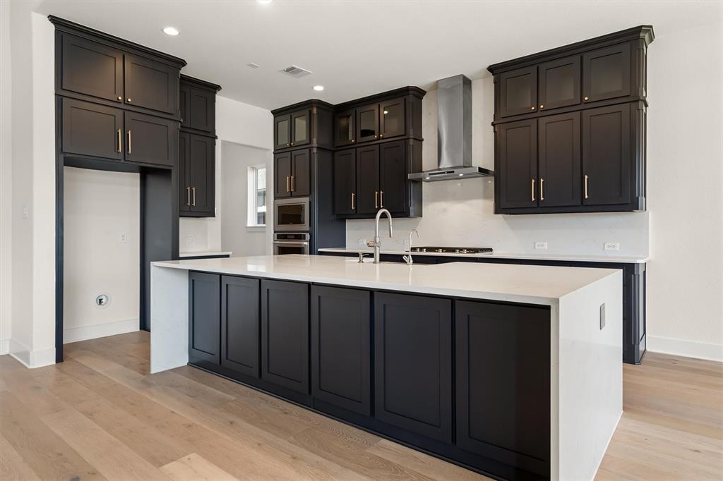 1161 Rochester Place Copper Canyon, TX 75077 - Photo 3 of 39 The kitchen is a true showpiece, featuring quartz counters, KitchenAid appliances, a 5-burner gas cooktop, vented range hood, a farmhouse sink within an oversized island, & an enormous walk-in pantry.