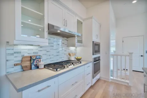 a kitchen with a stove and a refrigerator