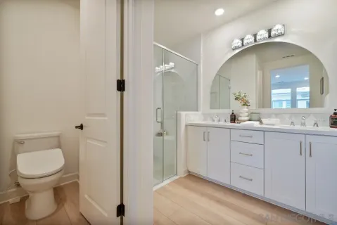 a spacious bathroom with a toilet sink and mirror