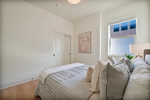 a bedroom with a bed and painting on the wall