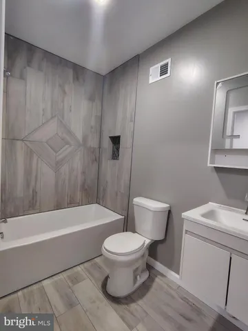a bathroom with a toilet a sink and bathtub