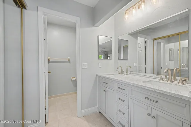 a bathroom with a granite countertop sink mirror and double